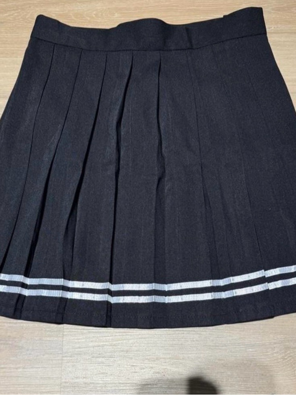 Classic Black Pleated Skirt with White Stripe Detail